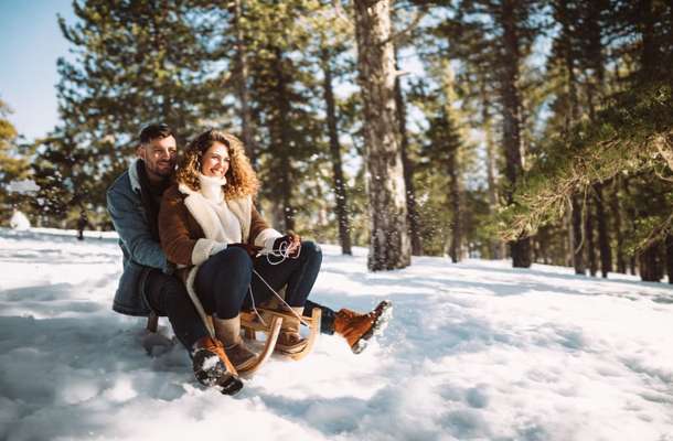 Couple sledding in Solang Valley